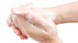 close up of two hands with soap, washing hands